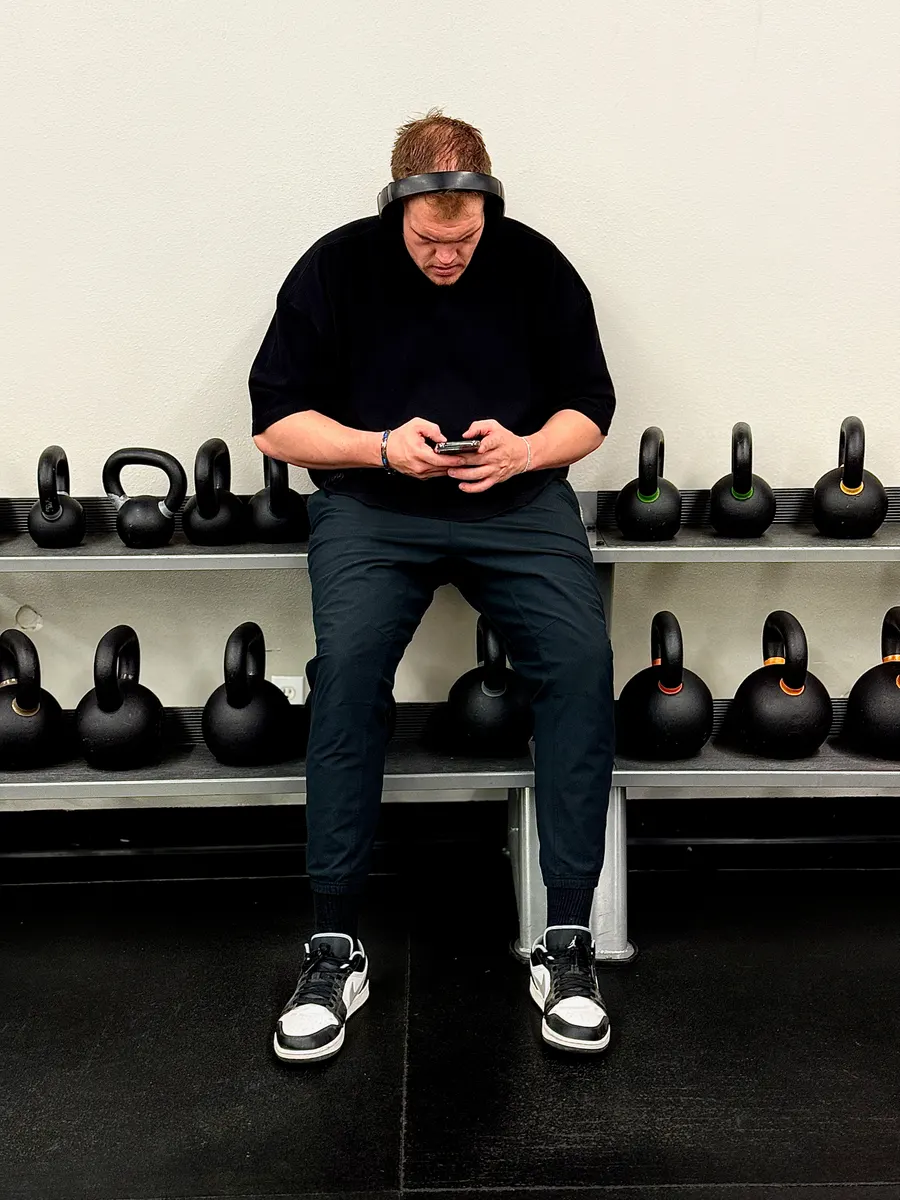 Sitting on the bench by the kettlebell rack between sets